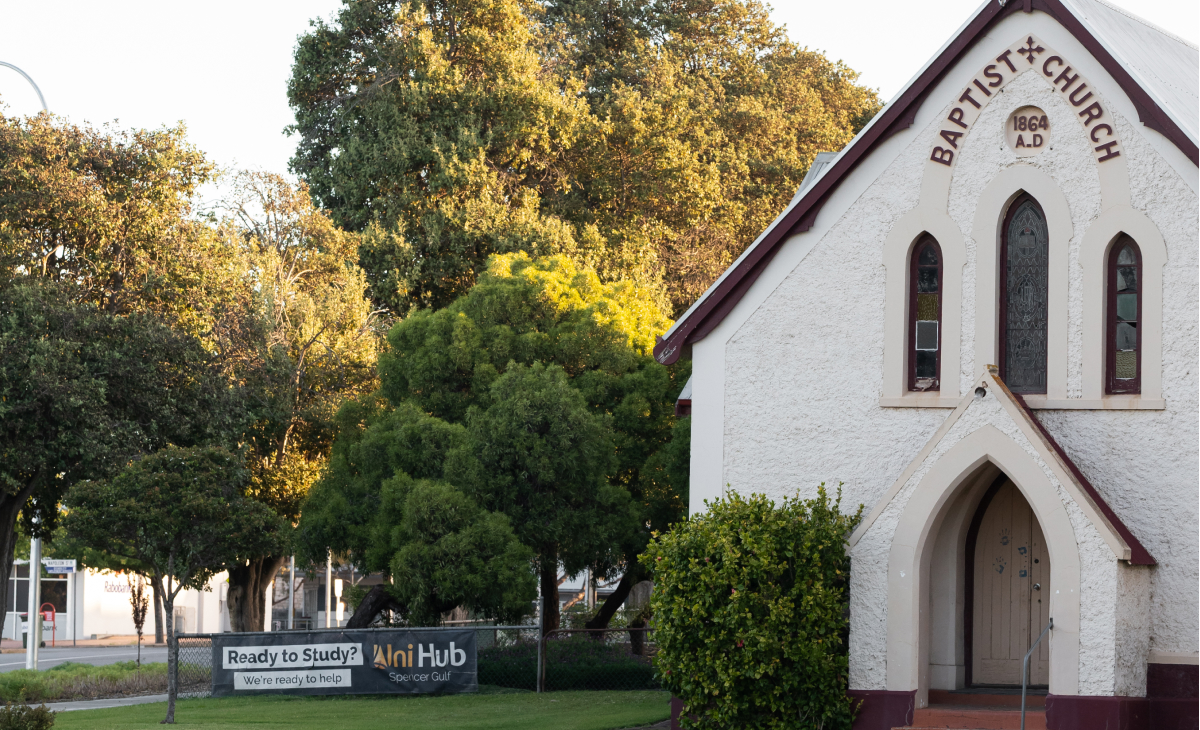 Uni Hub Spencer Gulf signage next to baptist church building